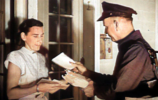 1940 Mailman hand-deliviering mail to housewife at her door